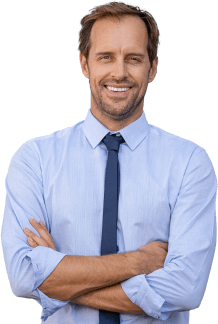 Man smiling crossing his arms wearing a blue shirt and blue tie